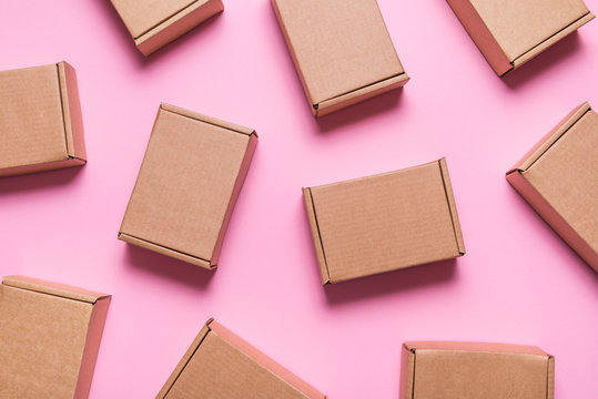 Lot of cardboard boxes on pink background