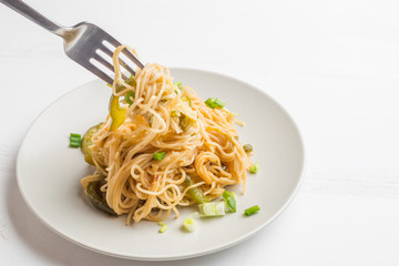 Closeup Spaghetti with chili, garlic,holy basil,olive oil and smoked chicken breast. East meets West.