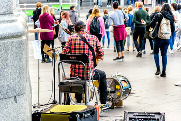 Melbourne, Victoria, Australia, May 26th 2018: A solo busker is sitting in front of the Flinders...