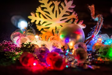 Obraz na płótnie Canvas Christmas decorative snowlake and bulbs in the dark.