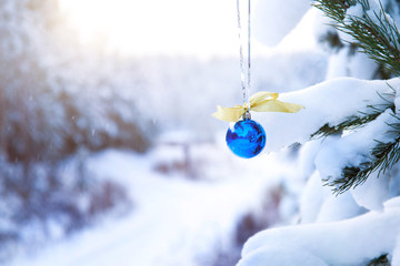 blue glass christmas ball with yellow bow