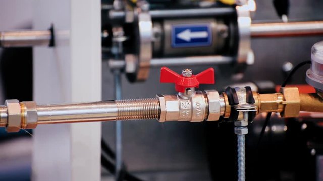 Water meters and ball valves installed on a metal pipe.