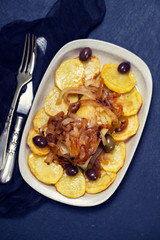 baked cod fish with potato, onion and olives