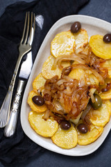 baked cod fish with potato, onion and olives