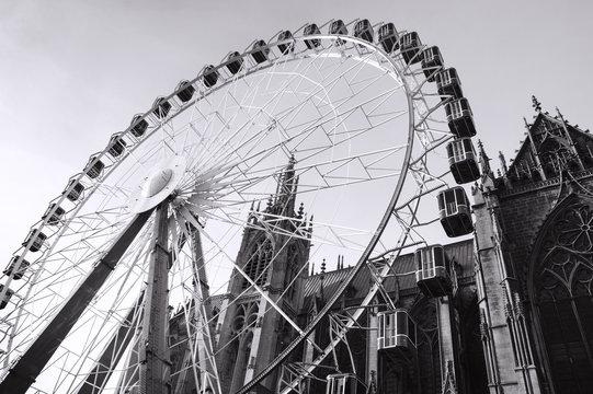 Christmas Ferris wheel in front of the cathedral of Metz. Metz, France.  Black white historic photo