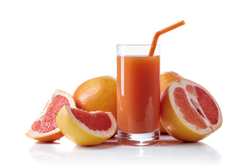 Glass of fresh grapefruit juice and cut fruits white background.