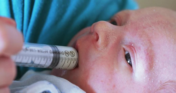 Artificial feeding of the child with a syringe