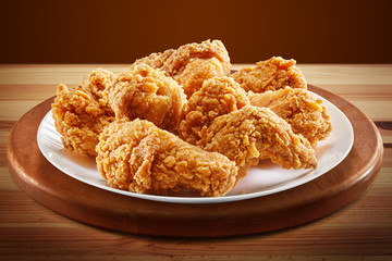 crispy coated batter southern style fried chicken in a wooden table