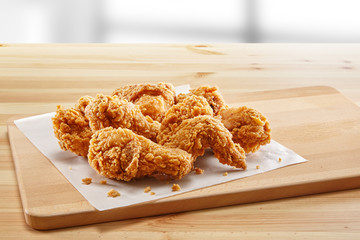 crispy coated batter southern style fried chicken in a wooden table