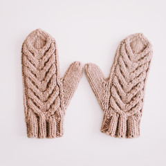 Warm knitted mittens isolated on white background. Flat lay, top view.