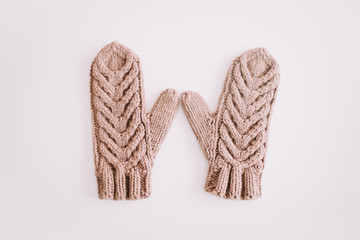 Warm knitted mittens isolated on white background. Flat lay, top view.