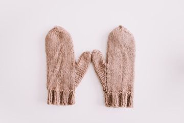 Warm knitted mittens isolated on white background. Flat lay, top view.