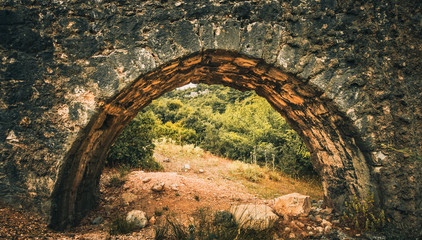 Ancient stone arch canal (Aqueduct) for water transportation. Kaynaklar village, Izmir, Turkey.