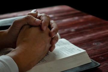Man Praying to God with His Bible, Prayer with Reading the Bible on the Wood Table