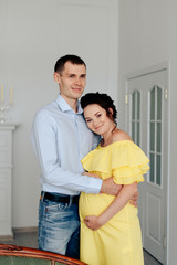Fototapeta premium young married couple waiting for a miracle, pregnant wife with her husband