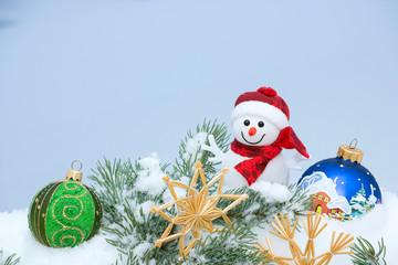 Christmas background with Christmas tree, snowman, handmade snowflakes and balls on a snow. Merry Christmas and happy new year.
