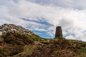 The Two Rock Mountain, Fairy Castle  summit on a cloudy day in Dublin, Ireland. Landscape of an Irish mountain peak under a blue sky with white clouds.