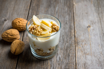 Healthy breakfast with banana and nuts. Selective focus.