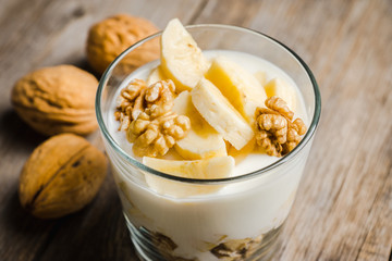 Healthy breakfast with banana and nuts. Selective focus.