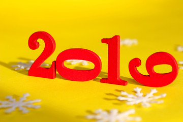 Christmas, Holidays, New Year Concept. Red Figures 2019 And White Snowflakes  Over Yellow Background. Colorful Background For New Year Card.
