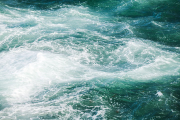 Fototapeta na wymiar Deep blue water with waves and foam