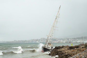 A nautical accident in which the sailboat beats hard on the rocks of the coast in the middle of a...