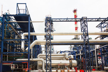 Close-up of pipelines and distillation tanks of an oil-refinery plant