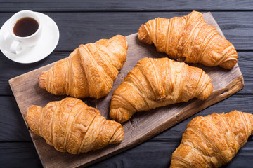Croissants on wooden background