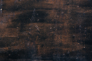 rough texture of a old black and brown wall.