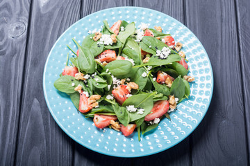 Strawberry salad with spinach , cheese and walnut . Healthy food