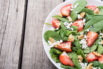 Strawberry salad with spinach , cheese and walnut . Healthy food