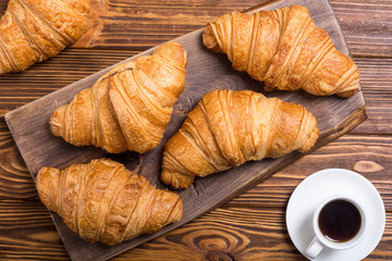 Croissants on wooden background