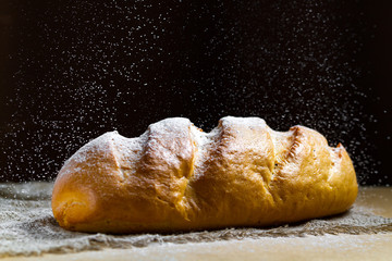 Long loaf from the bakery on the table. Bakery products. Bread from rye, wheat flour