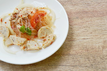 spicy glass noodles with slice Vietnamese sausage and onion Thai salad on plate