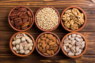 Mix of nuts : Pistachios, almonds , walnuts , pine nut , hazelnuts and cashew . Snack in bowl backgrond
