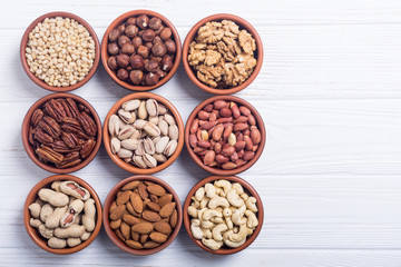 Mix of nuts : Pistachios, almonds , walnuts , pine nut , hazelnuts and cashew . Snack in bowl backgrond