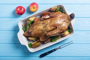 Homemade baked duck with potatoes and apple . Christmas food