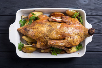 Homemade baked duck with potatoes and apple . Christmas food