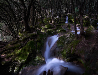 Natural waterfall of water in mediterranean forest. Spain. Balearic Islands