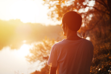 Young man enjoying the sunset sun