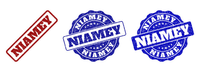 NIAMEY scratched stamp seals in red and blue colors. Vector NIAMEY labels with draft surface. Graphic elements are rounded rectangles, rosettes, circles and text labels.