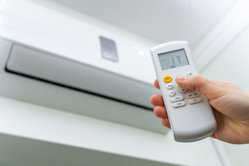 Air conditioner inside the room. Air conditioner with remote controller. Regulate the temperature...