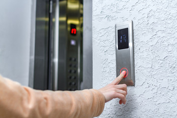 Elevator call. Man pressing elevator button