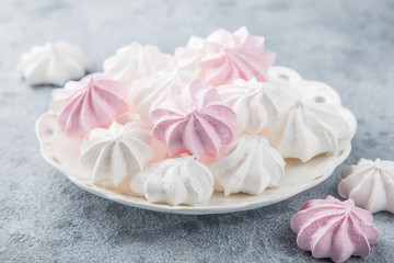 white and pink meringues on white plate