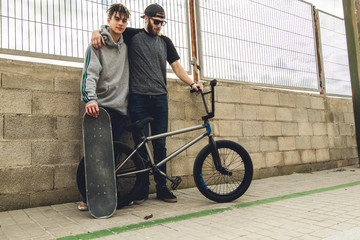 Young people with bmx and skateboard . Lifestyle concept of the millenials