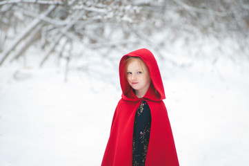 Girl in a red cloak with a hood