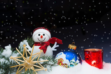 Christmas background with Christmas tree, snowman, candle, handmade snowflakes and balls on a snow....