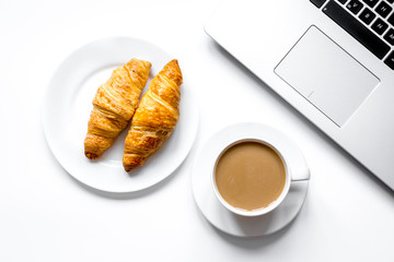 Coffee break in office on desk with laptop top view