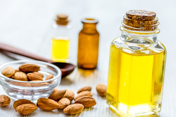 cosmetic set with almond oil on wooden table background