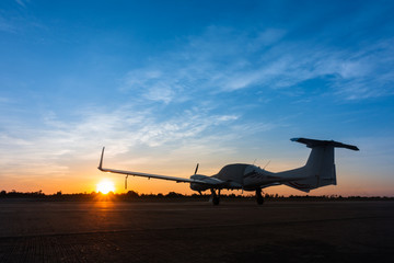 Shadow of a small landed plane  on the airfield and the Beautiful sunset sky background